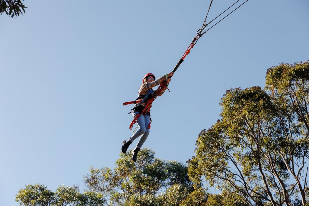 Child on school camp high ropes course
