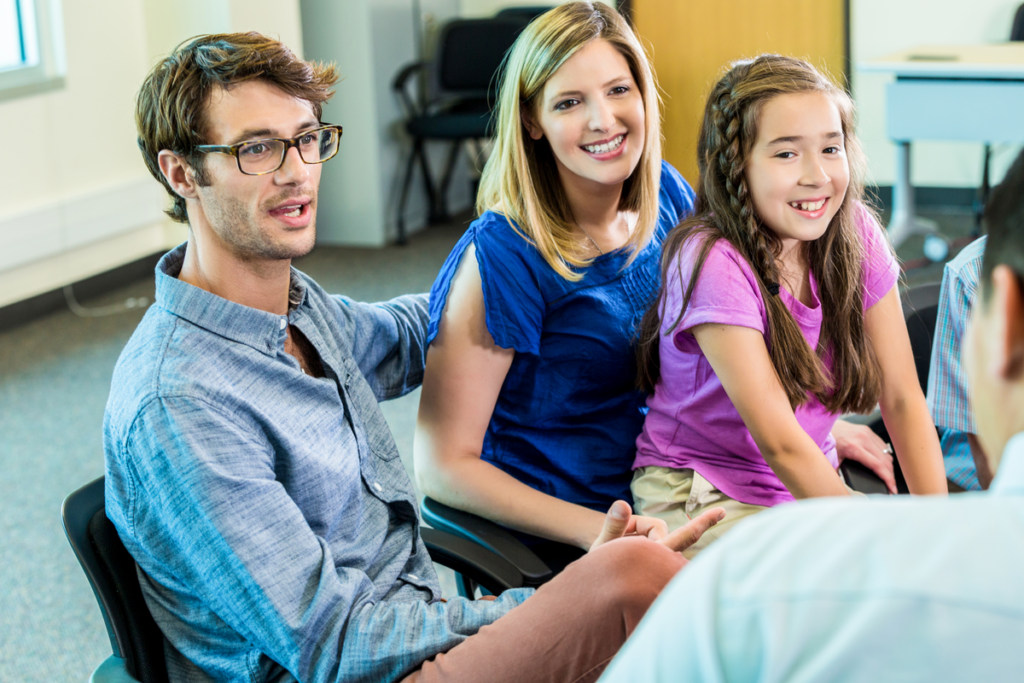 Family sitting in classroom