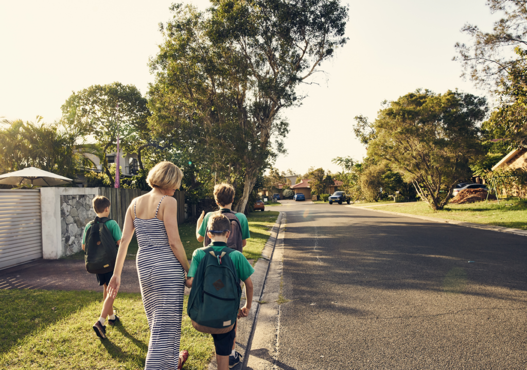 Mother walking children to school