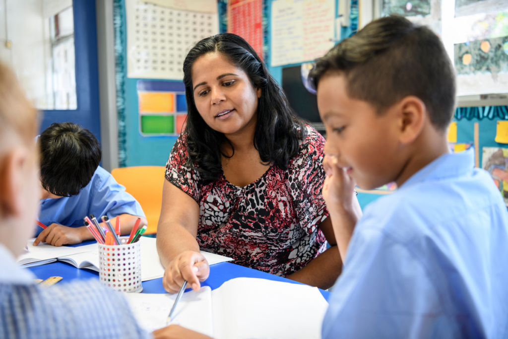 Female teacher helping student with schoolwork