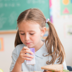 School child drinking juice