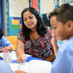 School teacher going through work with school children