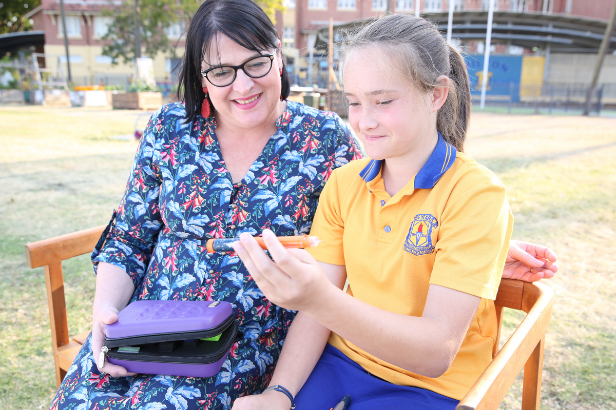 Teacher sitting with student on bench